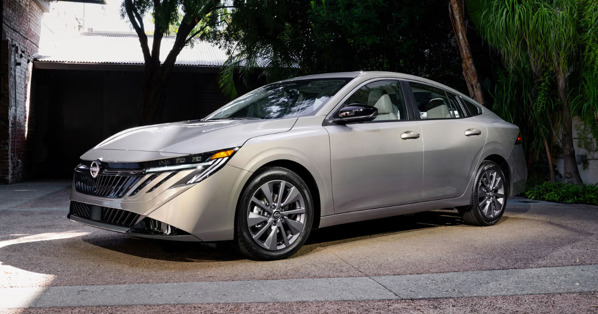 2026 Nissan Sentra parked in a driveway with a fence and palm trees in the background