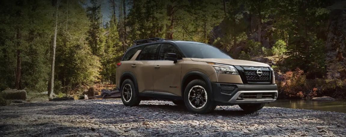 Nissan Rogue driving in a woodsy area